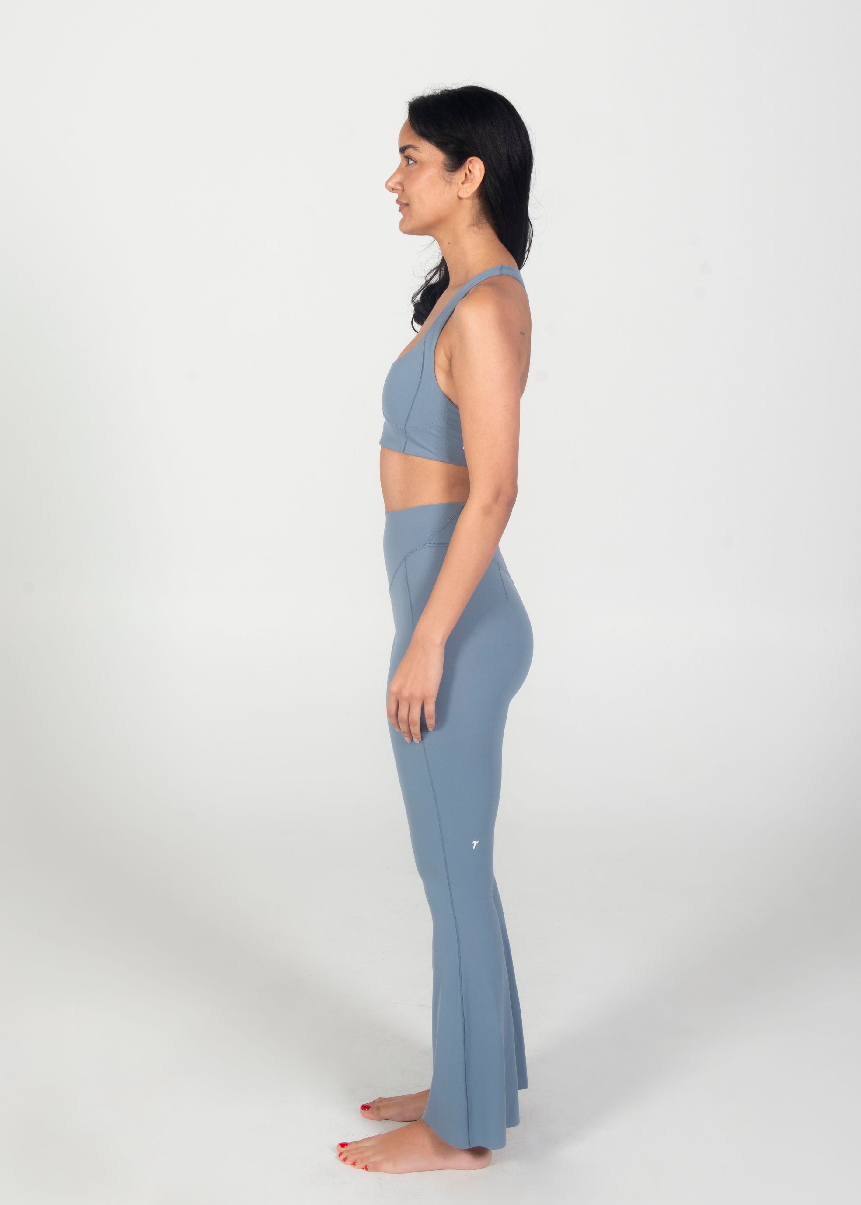 Woman wearing a blue athletic outfit on a white background
