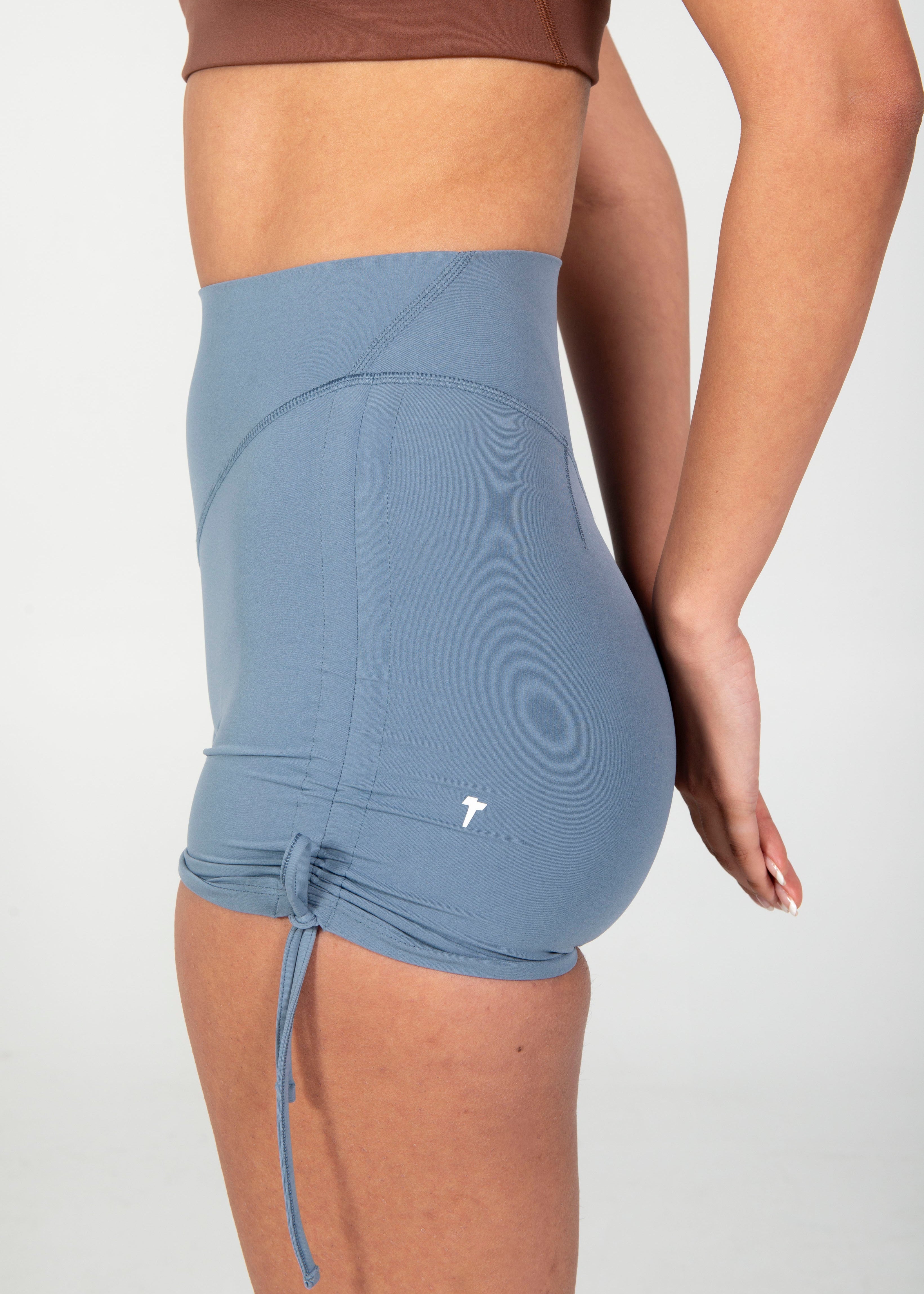 Blue athletic shorts with a brand logo on a white background