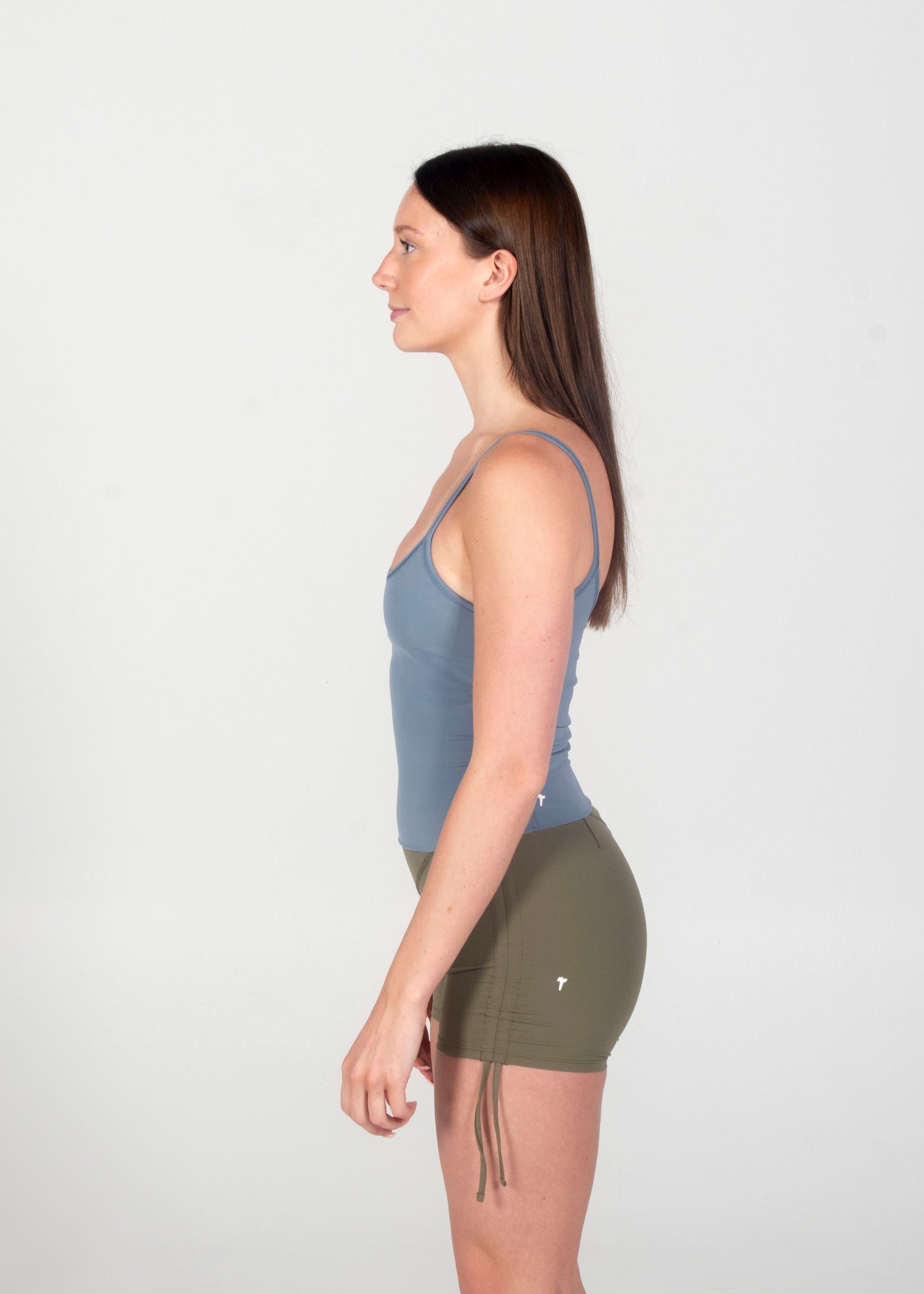 Woman standing in a yoga pose on a white background