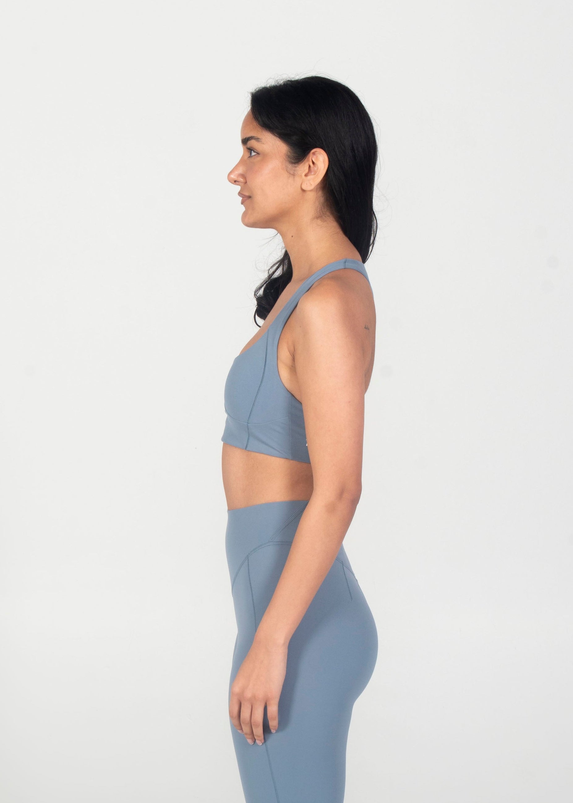 Woman wearing a blue athletic outfit on a white background